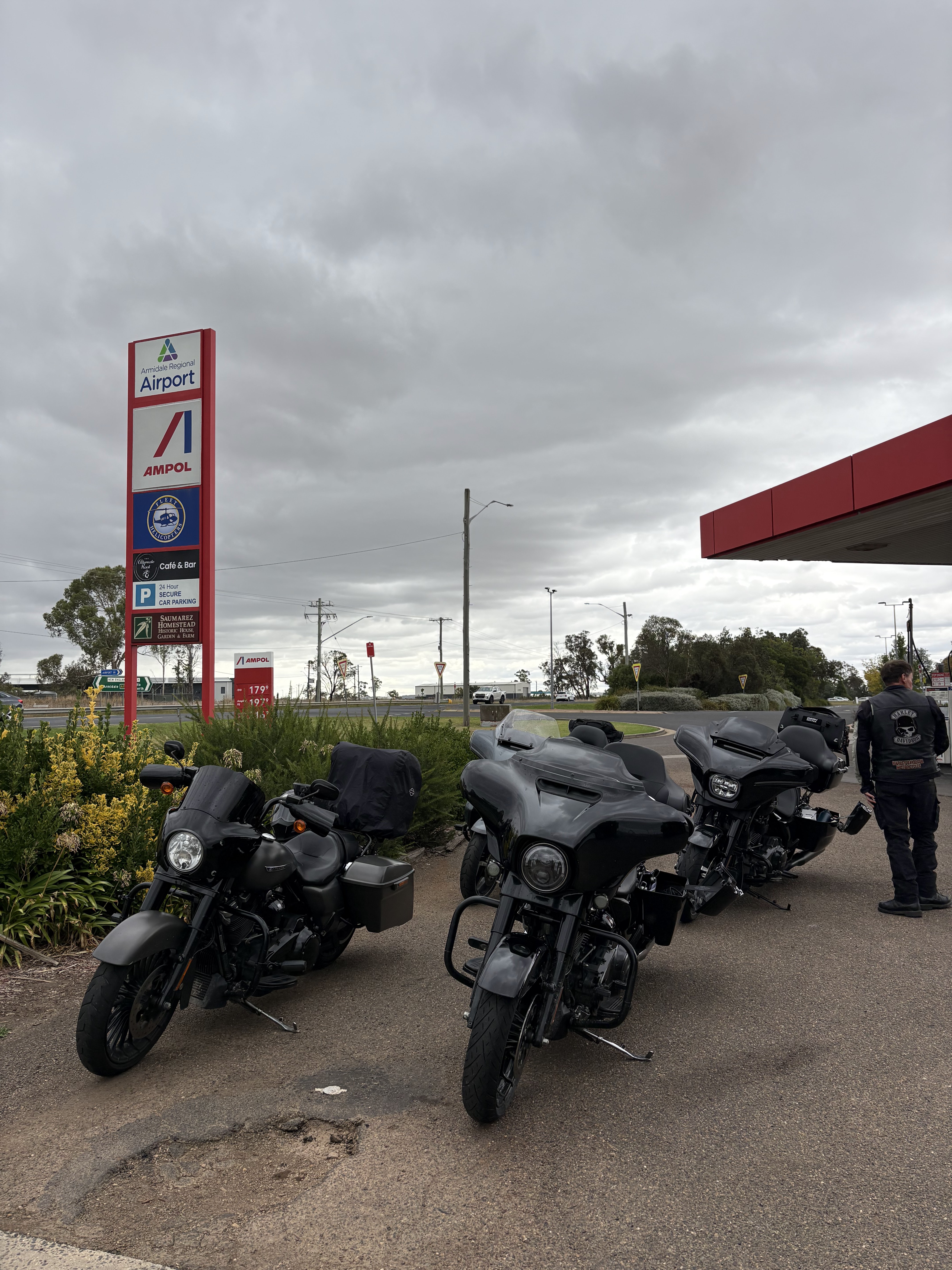 Three Harleys lined up at the Ampol, Armidale