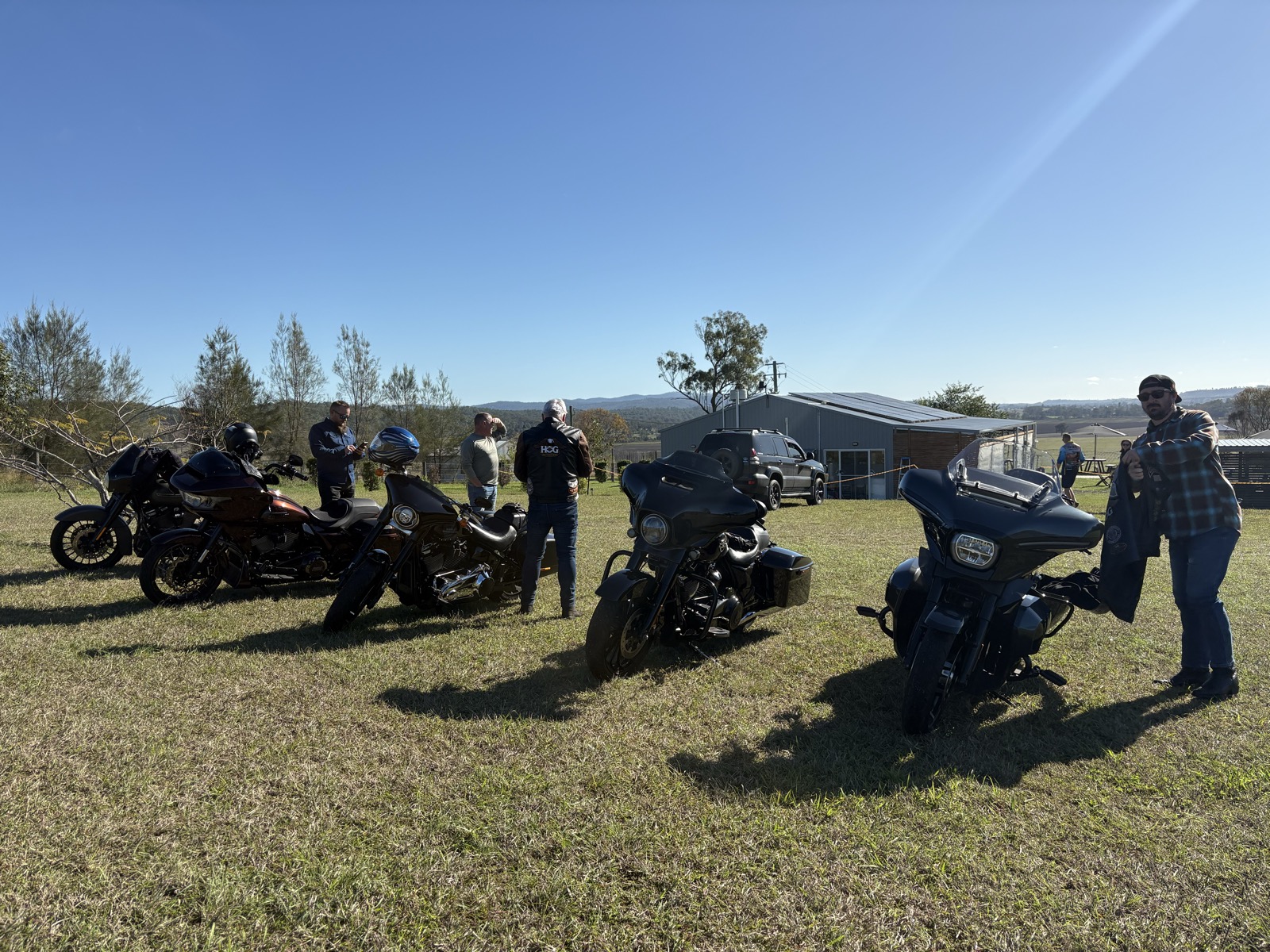 Bikes parked up on the hill at Oaky Creek Farm, the Scenic Rim stretching out behind